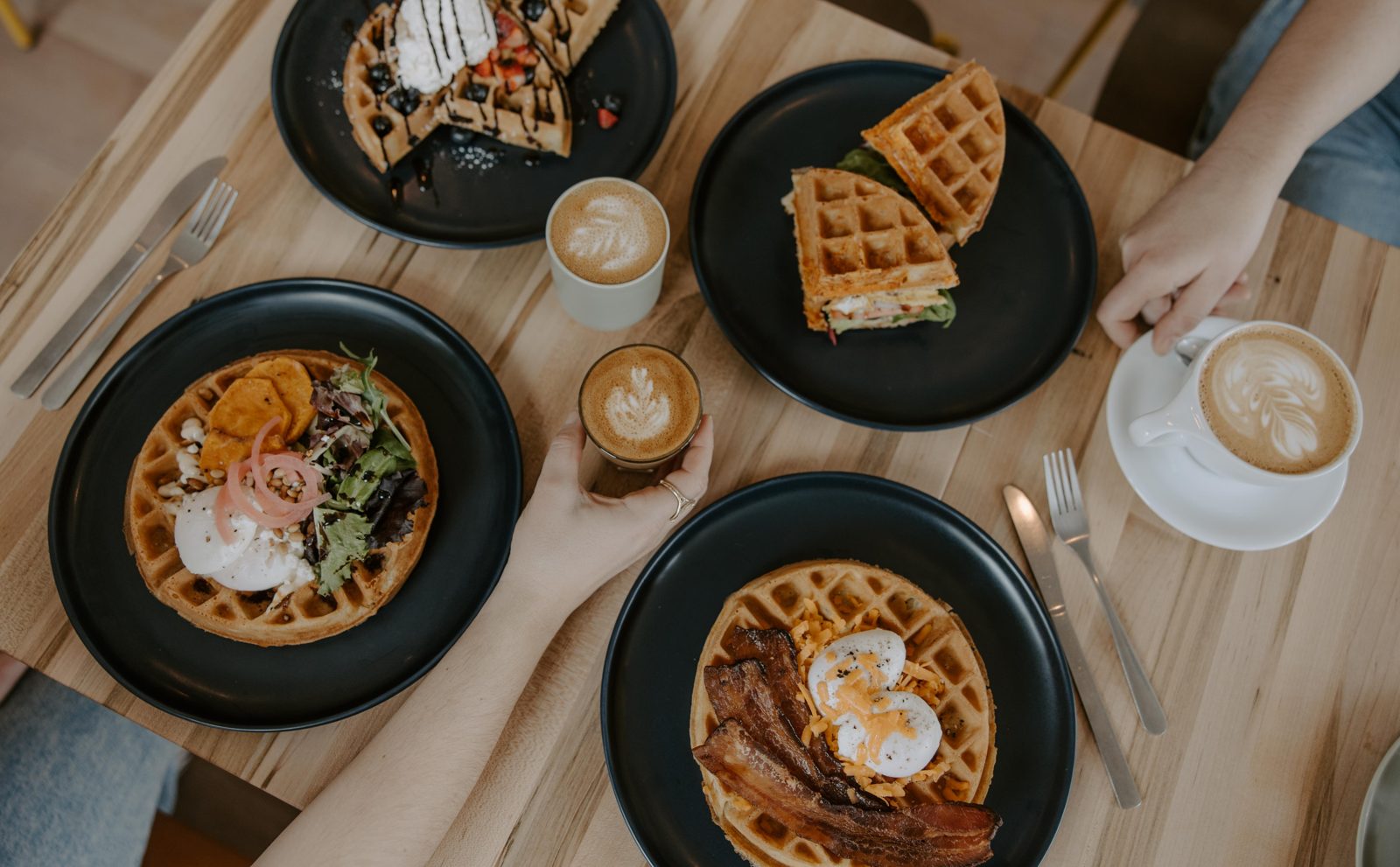 Friends sharing waffles and lattes